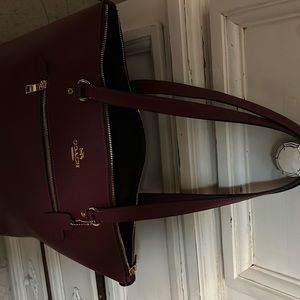 Coach hand bag brand new but need to clean out my closet burgundy beautiful